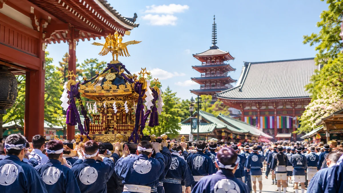Illustration of men in matching indigo happi coats carrying a gilded portable shrine through the Senso-ji grounds, the pagoda behind